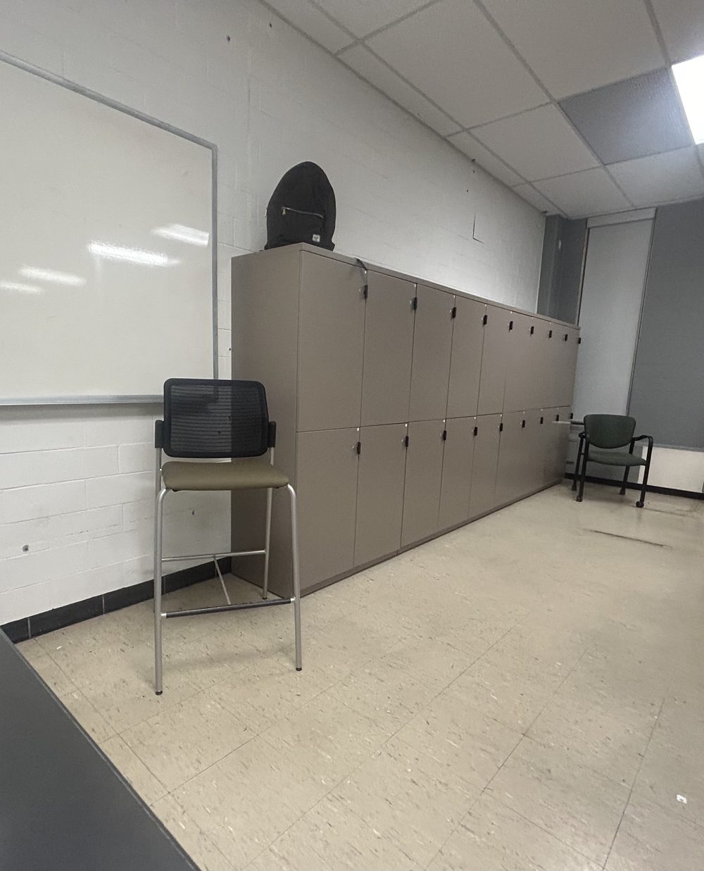 The lab scanned: whiteboard, lockers along one wall, chairs, tiled floor and drop ceiling